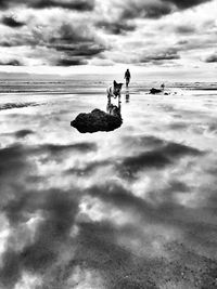 People on beach against sky