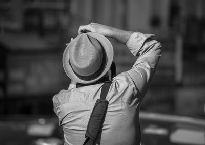 Rear view of man photographing outdoors