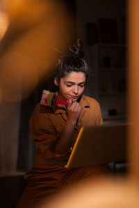 Young woman looking at canvas