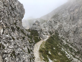 Scenic view of rocky mountains during foggy weather