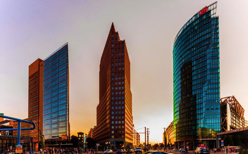 Low angle view of buildings against sky during sunset