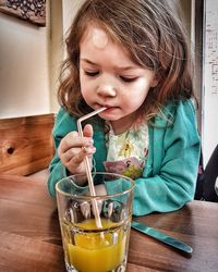 Close-up of a girl with drink on table