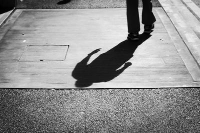 Low section of man walking on street