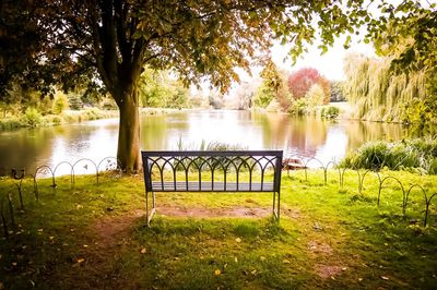 Gazebo by lake in park against sky