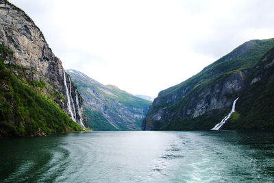 Scenic view of river amidst mountains against sky