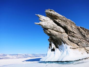 View of snowcapped mountain against clear blue sky