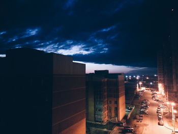 Illuminated city against sky at night