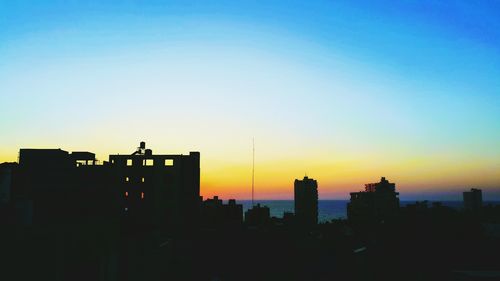 Silhouette of city at sunset