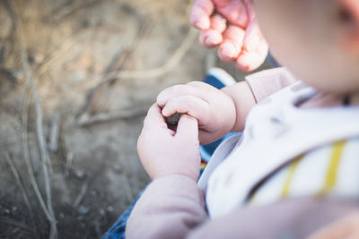 Close-up of hands holding baby hand