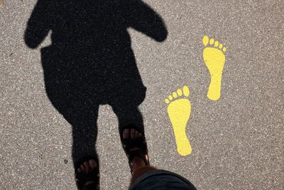 Low section of people standing on road