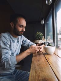 Man holding food on table