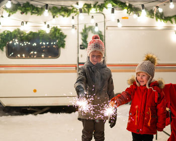 Cute kids playing with sparkler outdoors