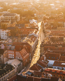 High angle view of illuminated street amidst buildings in town