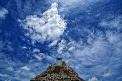 High section of baphuon temple against cloudy sky