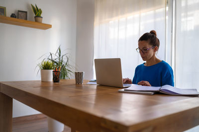 Businesswoman using laptop at office