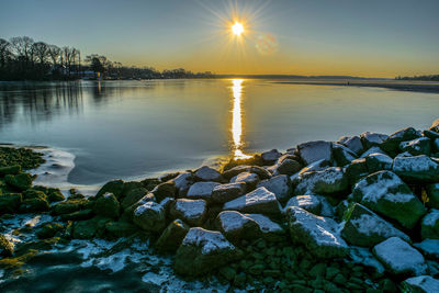 Scenic view of lake against sky during sunset