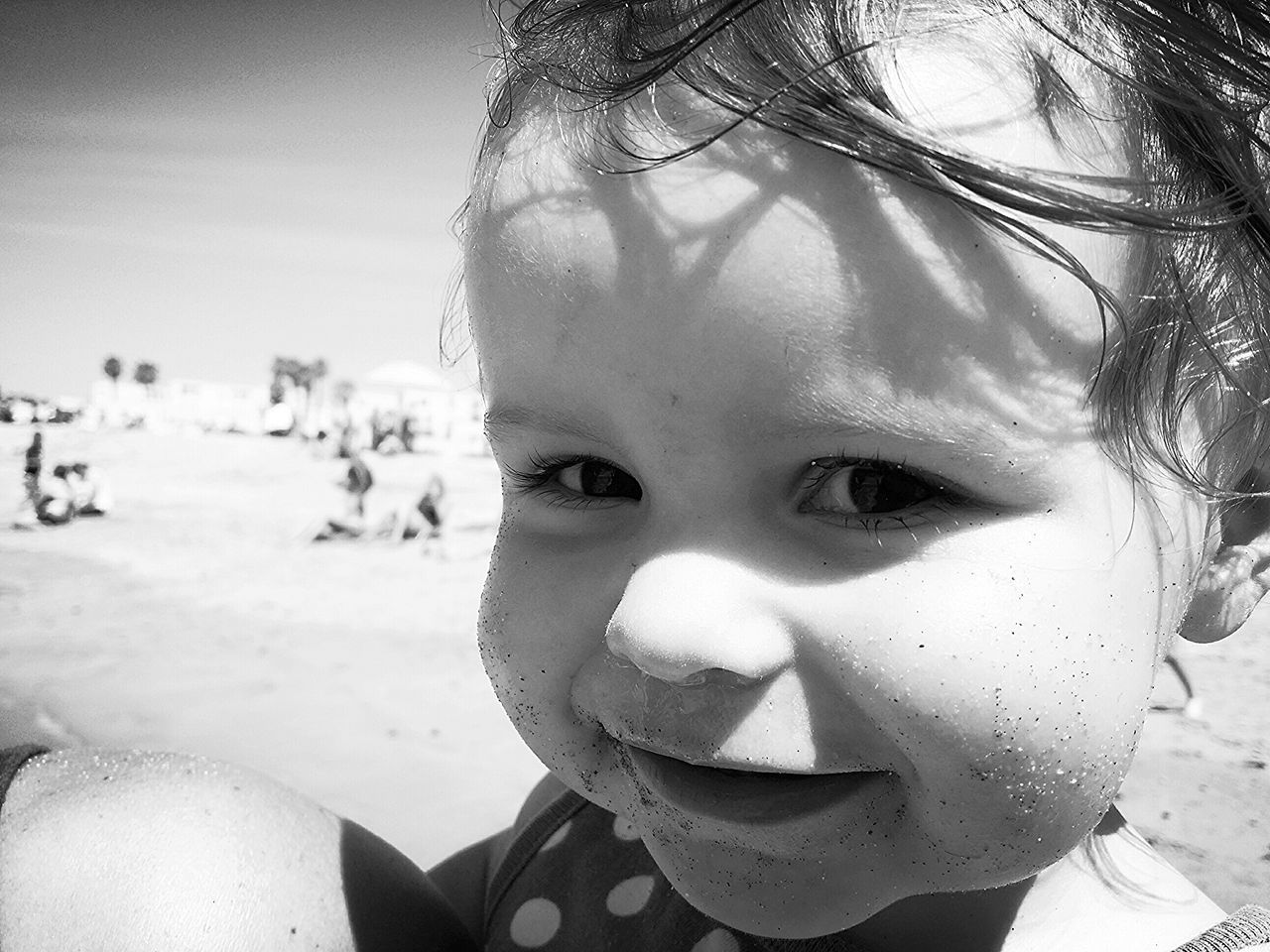 headshot, portrait, person, looking at camera, lifestyles, young adult, leisure activity, close-up, front view, focus on foreground, young women, sunlight, smiling, human face, sunglasses, beach, head and shoulders, outdoors