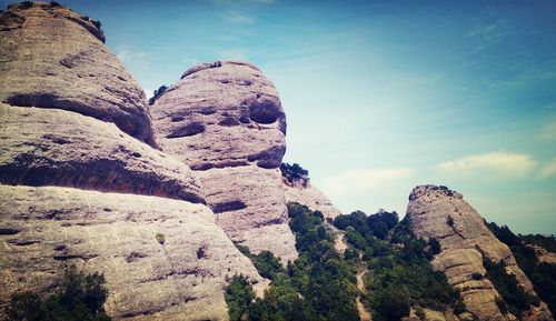 Low angle view of rock formation against sky