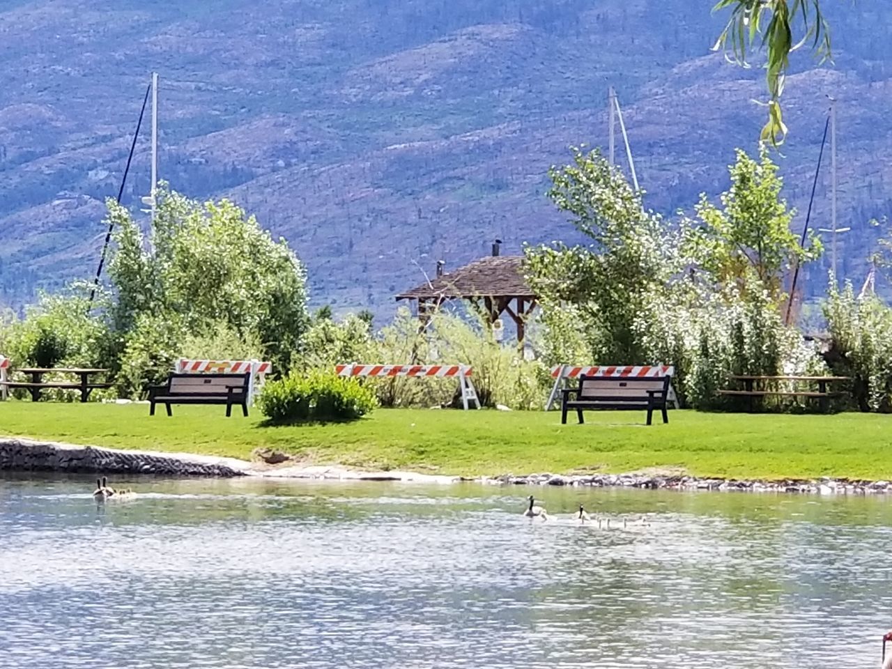 BUILT STRUCTURE BY LAKE AGAINST TREES