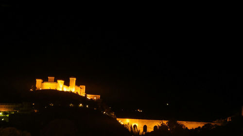 Low angle view of illuminated building against sky at night