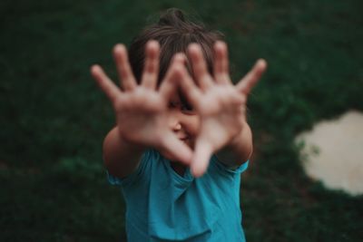 Midsection of person with hands covering face