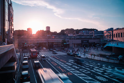 Traffic on city street during sunset