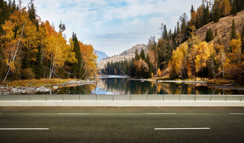 Scenic view of lake by trees against sky during autumn