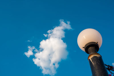 Low angle view of street light against blue sky