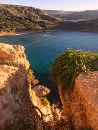 High angle view of rocks on sea shore against sky