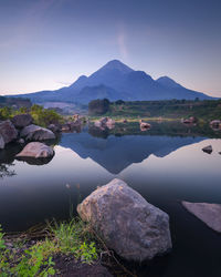 Scenic view of lake and mountains against sky