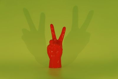 Close-up of red chili pepper against green background