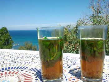 Close-up of beer in glass on table against clear sky