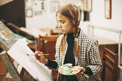 Woman sitting by indoors