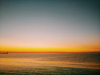 Scenic view of sea against romantic sky at sunset