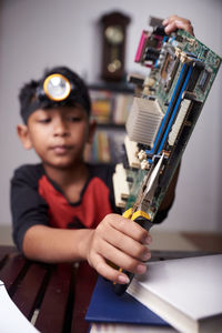 Portrait of boy holding camera