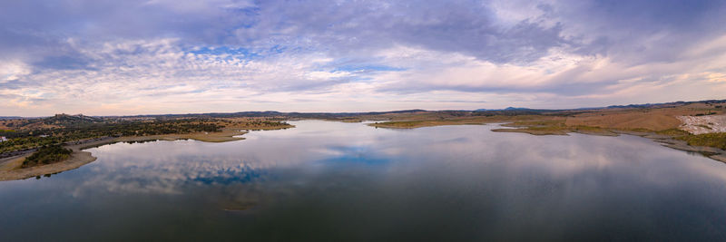 Drone aerial panorama of a dam lake reservoir landscape in terena, portugal