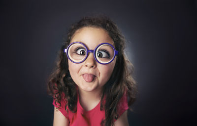 Portrait of girl against black background