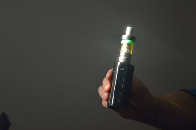 Cropped image of person holding electronic cigarette