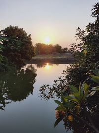 Scenic view of lake against sky during sunset