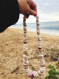 Close-up of hands on beach