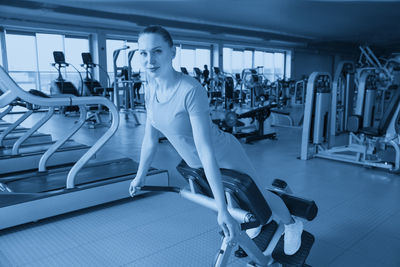 Portrait of woman exercising in gym