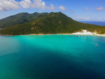 Scenic view of sea and mountains against sky