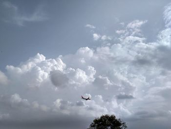 Low angle view of helicopter flying in sky