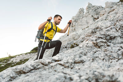 Rear view of man standing on rock