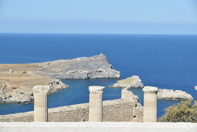 Scenic view of built structure by sea against clear sky