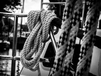 Close-up of rope tied on railing in sailboat