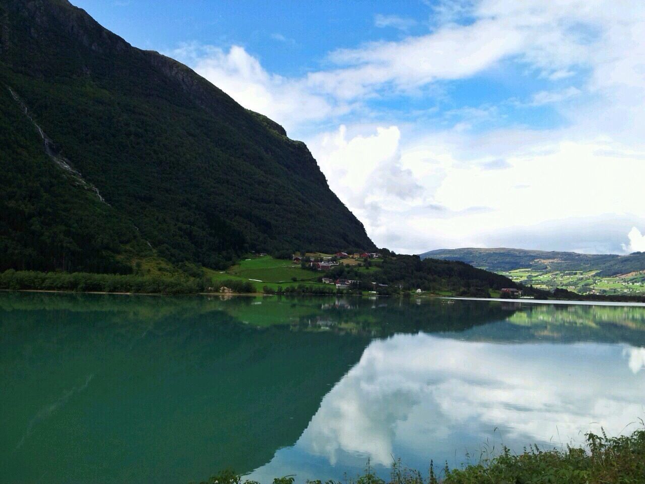 mountain, water, lake, tranquil scene, tranquility, reflection, sky, scenics, mountain range, beauty in nature, nature, cloud - sky, tree, landscape, cloud, river, standing water, idyllic, non-urban scene, waterfront