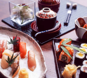 High angle view of sashimi and sushi served on table