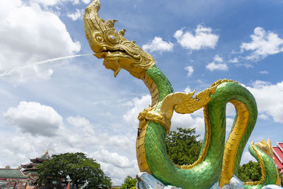 Low angle view of statue of angel against sky