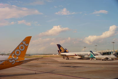 Airplane on runway against sky